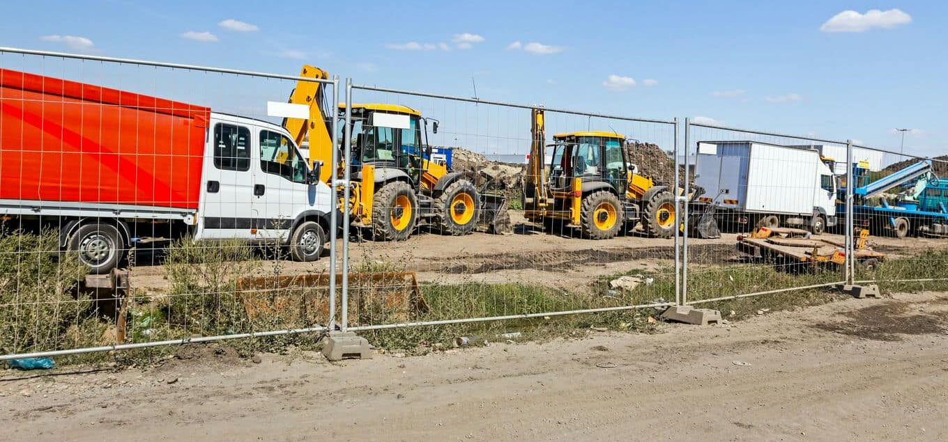 maszyny budowlane za ogrodzeniem tymczasowym